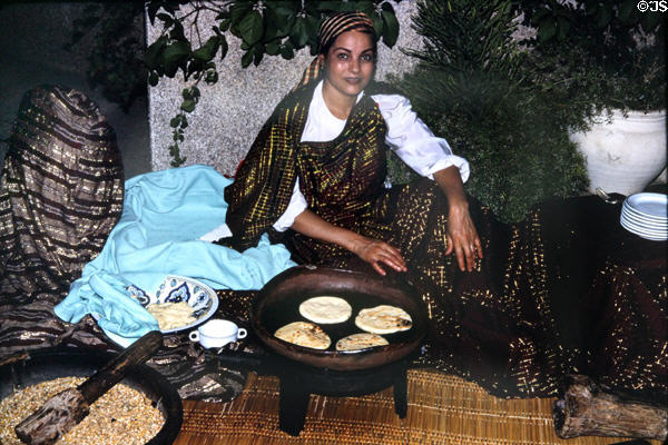Serving meal in traditional manner. Tunis, Tunisia.