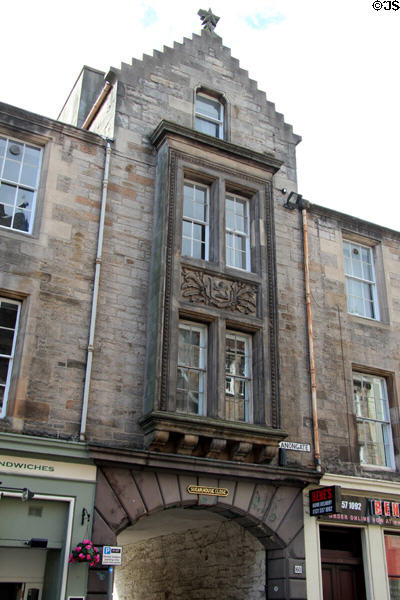 Carved building with archway to Sugarhouse Close off Canongate St. Edinburgh, Scotland.