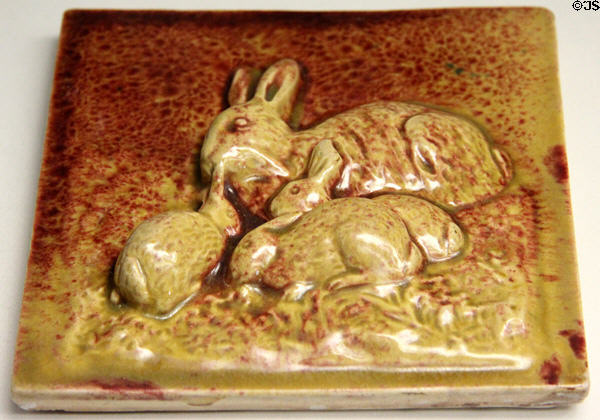 Earthenware tile with rabbits of yellow & red glazes by Dunmore Pottery at Museum of Edinburgh. Edinburgh, Scotland.
