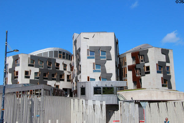 Scottish Parliament section with abstract cantilever shapes which mimic famous Scottish painting of Skating Minister over wall of staves. Edinburgh, Scotland.