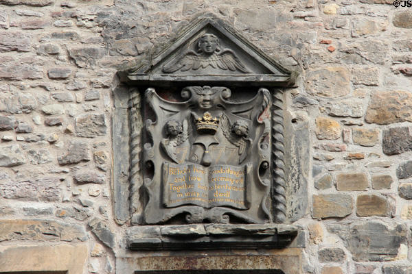 Carved plaque with angels (1677) on heritage building near Canongate on Royal Mile. Edinburgh, Scotland.