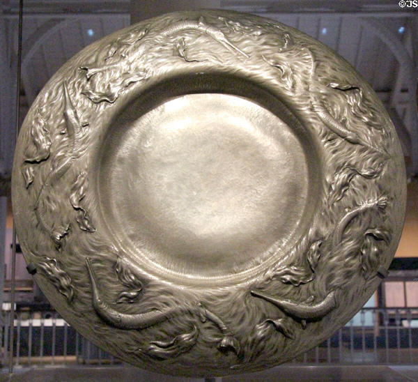 Pewter Art Nouveau charger with dolphins & waves (1901) by Gilbert Marks of London at National Museum of Scotland. Edinburgh, Scotland.