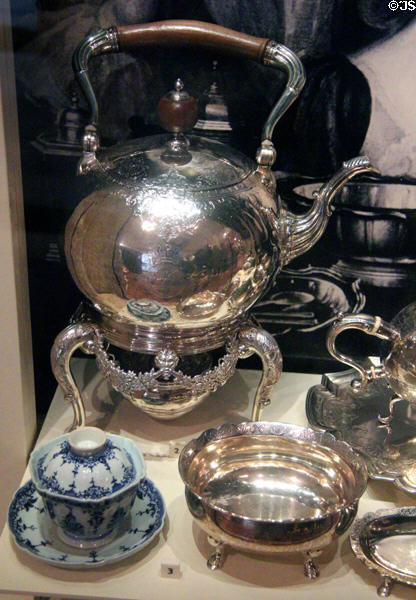 Silver tea service (1734-5) by James Ker of Edinburgh plus lidded porcelain tea cup (c1720) at National Museum of Scotland. Edinburgh, Scotland.