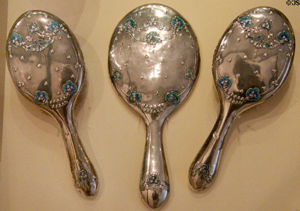 Silver hairbrush & mirror set (1911) by Jessie M. King made by WH Haseler of Birmingham for Liberty & Co. of London at National Museum of Scotland. Edinburgh, Scotland.