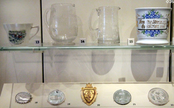 Ceramic, glass & metal souvenirs from Edinburgh International Exhibition badges (1886) at National Museum of Scotland. Edinburgh, Scotland.