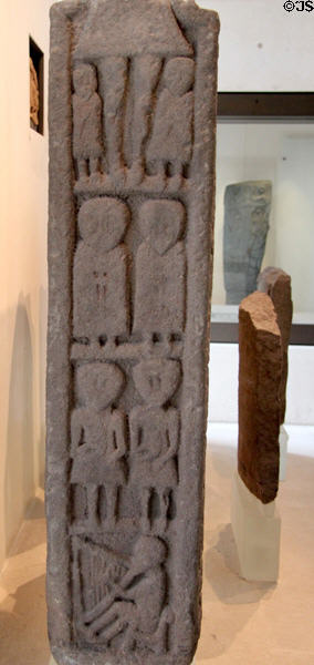 Pictish stone cross shaft carved with Christ, saints & David playing harp from Monifieth at National Museum of Scotland. Edinburgh, Scotland.