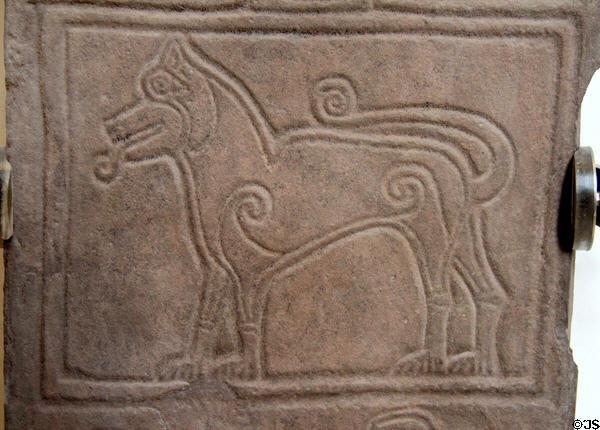 Symbolic Pictish animal with coiled design elements (700-900) on Papil cross at National Museum of Scotland. Edinburgh, Scotland.