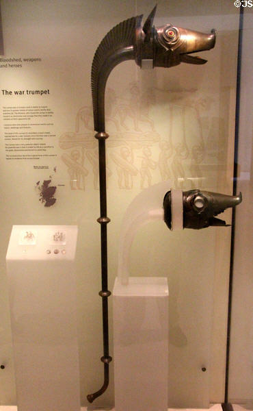 Reconstruction of northern Scottish Carnyx war trumpet whose sound in battle lead Romans to call their enemies Carnyx beside original head (100-200) from Deskford at National Museum of Scotland. Edinburgh, Scotland.
