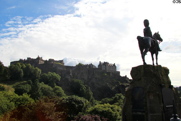 Royal Scots Greys Monument silhouetted against Edinburgh Castle. Edinburgh, Scotland.
