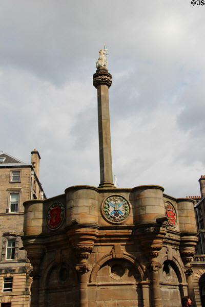 Market cross topped by unicorn beside St Giles Cathedral. Edinburgh, Scotland.