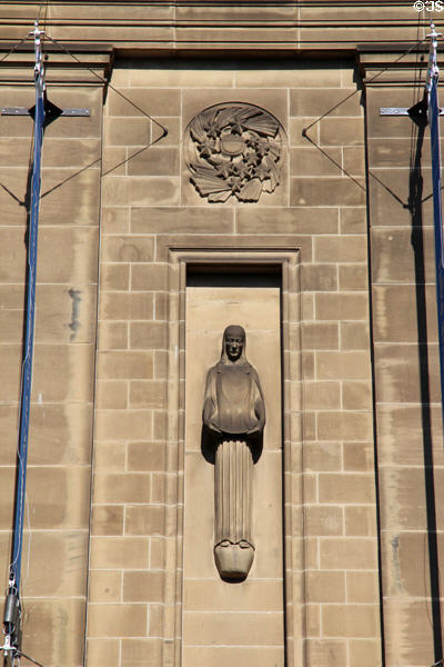 Sculpted figure by Hew Lorimer under rondel by E. Dempster on facade of National Library of Scotland. Edinburgh, Scotland.