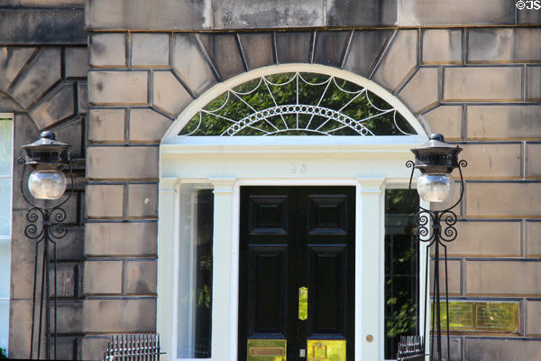 Fanlight over doorway flanked by lamps on Charlotte Square. Edinburgh, Scotland.