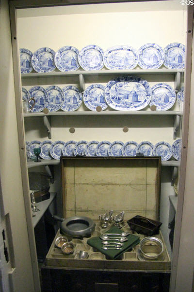 Pantry safe with porcelain dinnerware & silver dishes at Georgian House museum. Edinburgh, Scotland.