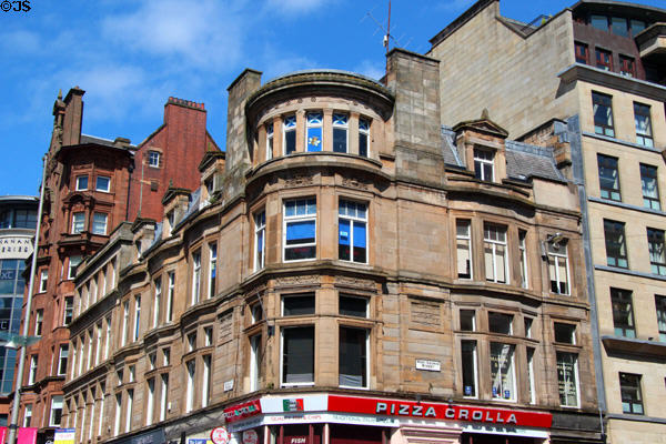 Grecian-style sandstone commercial building with chamfered corner bays (c1877) (Buchanan St. Mall at West George St.). Glasgow, Scotland. Architect: James Sellars.