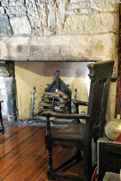 Scottish oak great chair (17thC) before fireplace with iron grate at Provand's Lordship. Glasgow, Scotland.
