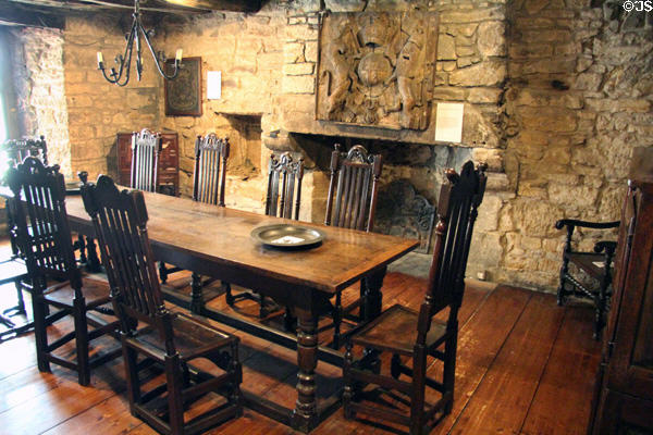 Scottish oak table & chairs (17th C) before fireplace with carved royal coat of arms of Charles II (c1660-85) at Provand's Lordship. Glasgow, Scotland.