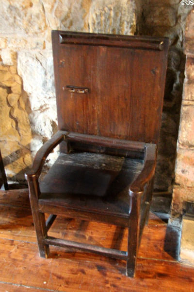 Tilt-top table which opens to become armchair with tall back at Provand's Lordship. Glasgow, Scotland.