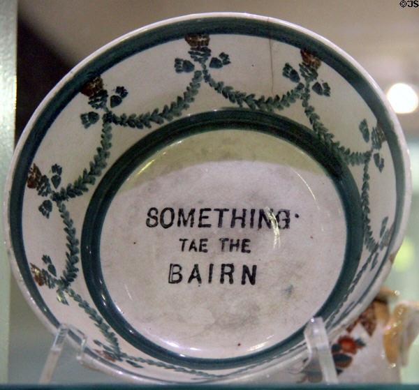 Ceramic bowl with thistle swags & legend "Something tae the bairn" (c1900) possibly by J & MP Bell Co. of Glasgow at Hunterian Museum. Glasgow, Scotland.