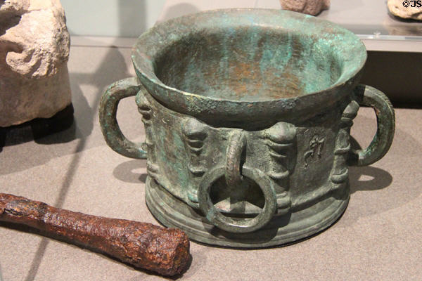 Copper alloy mortar (1300s-1400s) & iron pestle (1500s-1600s) from Glasgow cathedral at Kelvingrove Art Gallery. Glasgow, Scotland.