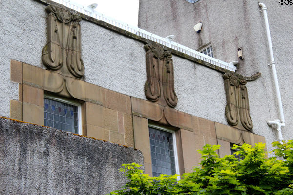 Sandstone carvings as conceived by C.R. Mackintosh on facade of House for an Art Lover. Glasgow, Scotland.