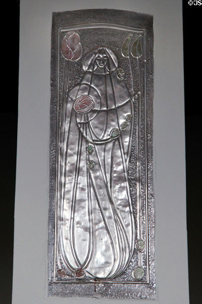 Metal plaque in style of Margaret Macdonald on hall pillar at House for an Art Lover. Glasgow, Scotland.