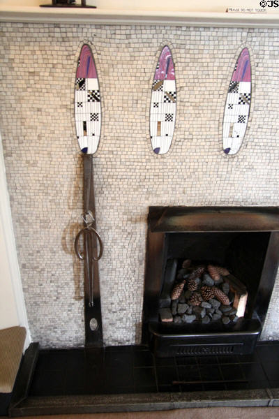 Steel fireplace grasping tool (1904) by C.R. Mackintosh on drawing room fireplace at Hill House. Helensburgh, Scotland.