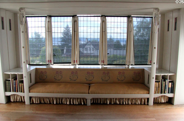 Window seat (1904) with many signature designs of C.R. Mackintosh in drawing room at Hill House. Helensburgh, Scotland.