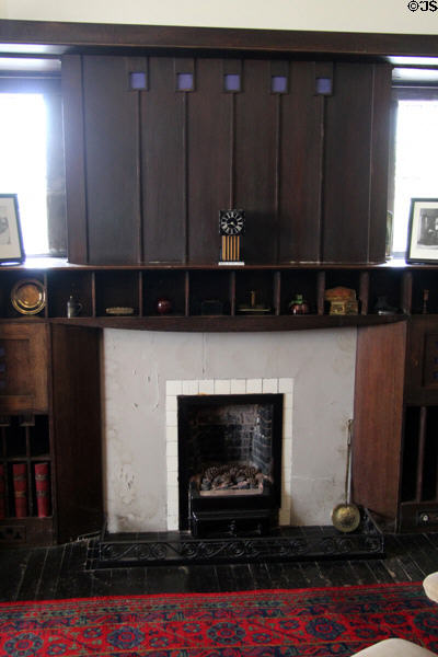 Library fireplace with C.R. Mackintosh cube clock on mantle at Hill House. Helensburgh, Scotland.