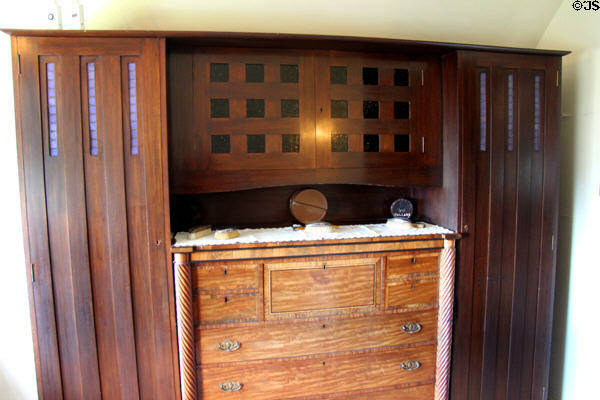 Cupboard by C.R. Mackintosh built around older chest of drawers Blackie family owned prior in dressing room at Hill House. Helensburgh, Scotland.