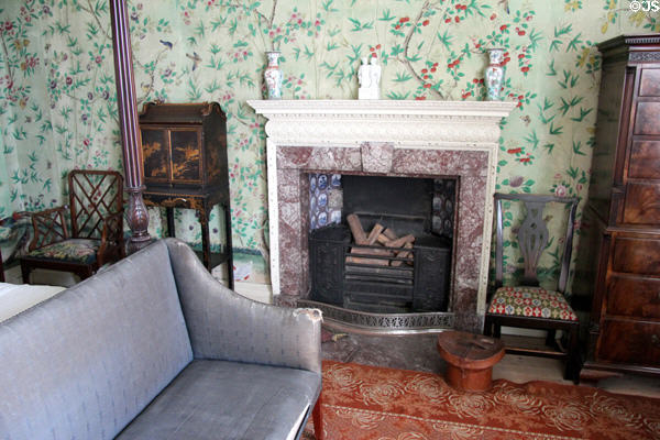 Fireplace with Chinese style furniture in Kier bedroom at Pollok House. Glasgow, Scotland.