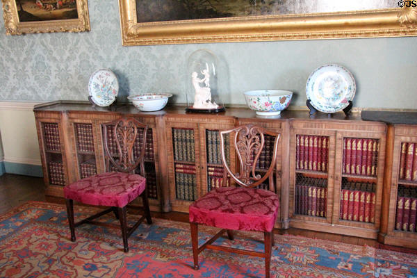 Long bookcase (1820s) supporting porcelain in Blue drawing room at Culzean Castle. Maybole, Scotland.