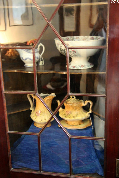 Corner cabinet with ceramics in Andrew Carnegie Birthplace Cottage. Dunfermline, Scotland.