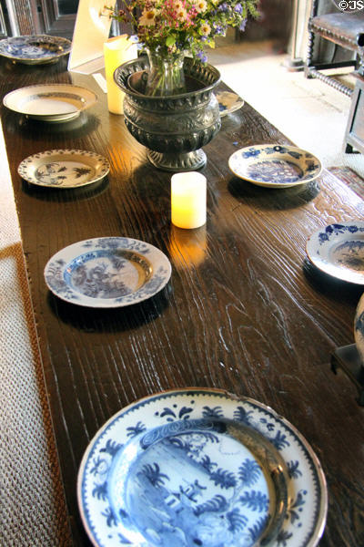 Dining table laid with ceramic plates in High Hall at Culross Palace. Culross, Scotland.