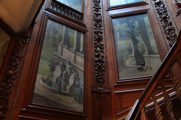 Mural framed in carvings created by Scottish wood carver Alexander Eizat on staircase at Hopetoun House. Queensferry, Scotland.