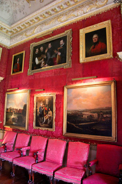 Art work on red damask wall in Red Drawing Room at Hopetoun House. Queensferry, Scotland.