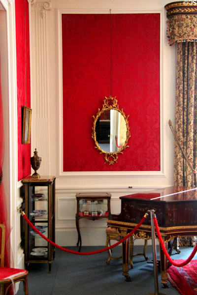 Piano & ornate, gold framed oval mirror in withdrawing room at Lauriston Castle. Edinburgh, Scotland.
