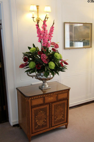 Anteroom cabinet with flower arrangement on Royal Yacht Britannia. Edinburgh, Scotland.