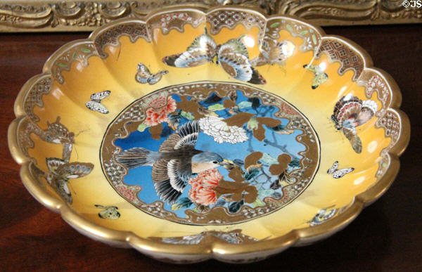 Antique bowl with blue center & yellow rim painted with bird & butterflies at Manderston House. Duns, Scotland.