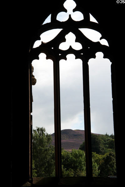 Surrounding hills seen through window of Melrose Abbey. Melrose, Scotland.