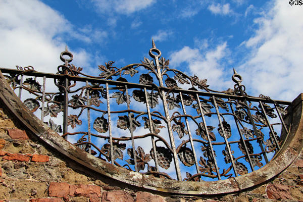 Sculpted cast iron screen over entrance at Priorwood Garden. Melrose, Scotland.