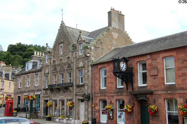 Heritage building (19thC) on Melrose Market Square with projecting clock (1892). Melrose, Scotland.