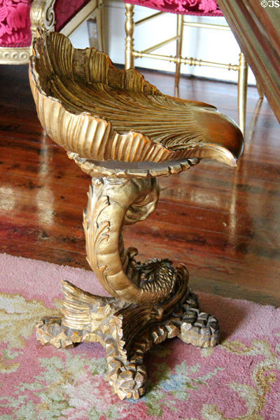 Rococo style piano stool supported by carved dolphin at Thirlestane Castle. Scotland.
