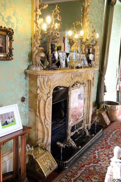 Large drawing room fireplace (1840) from Siena supporting elaborate lamps at Thirlestane Castle. Scotland.