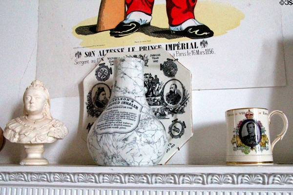 Antique inhaler flanked by royal souvenirs in nursery at Thirlestane Castle. Scotland.