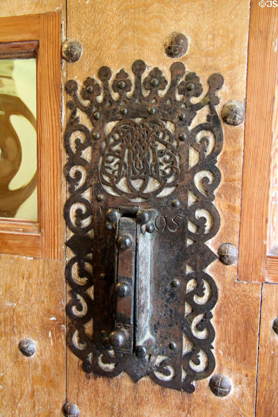 Metalwork door knocker (1705) on front door at Traquair House. Scotland.