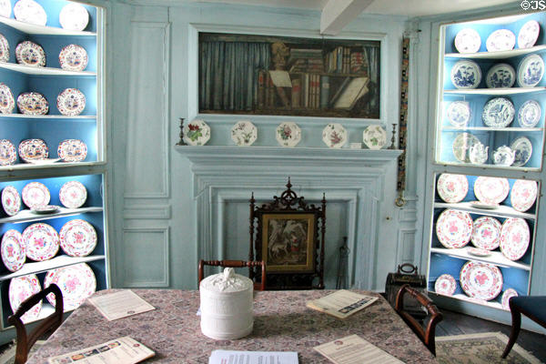 Still room, for preserves in 1800s, now displays china collection plus unusual painting of books over fireplace at Traquair House. Scotland.