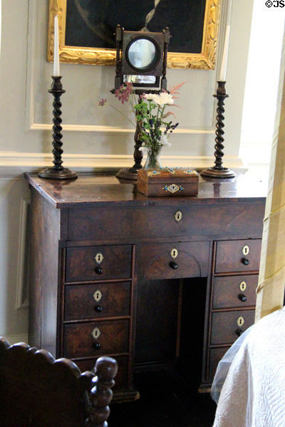 Kneehole desk supporting shaving mirror & candlesticks at Traquair House. Scotland.