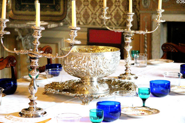 Table setting with candlesticks & punchbowl in dining room at Traquair House. Scotland.