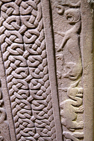 Pictish Droston stone front detail of lace of cross edged by compressed camel & lion at St Vigeans Museum. Arbroath, Scotland.