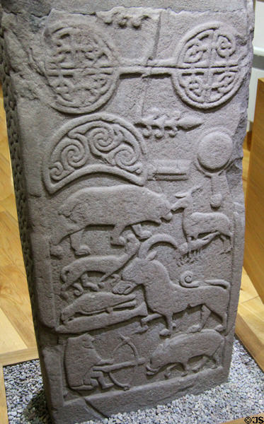 Pictish cross-slab (back Droston stone) detail of double paddle over crescent with swirls above animal scenes at St Vigeans Museum. Arbroath, Scotland.